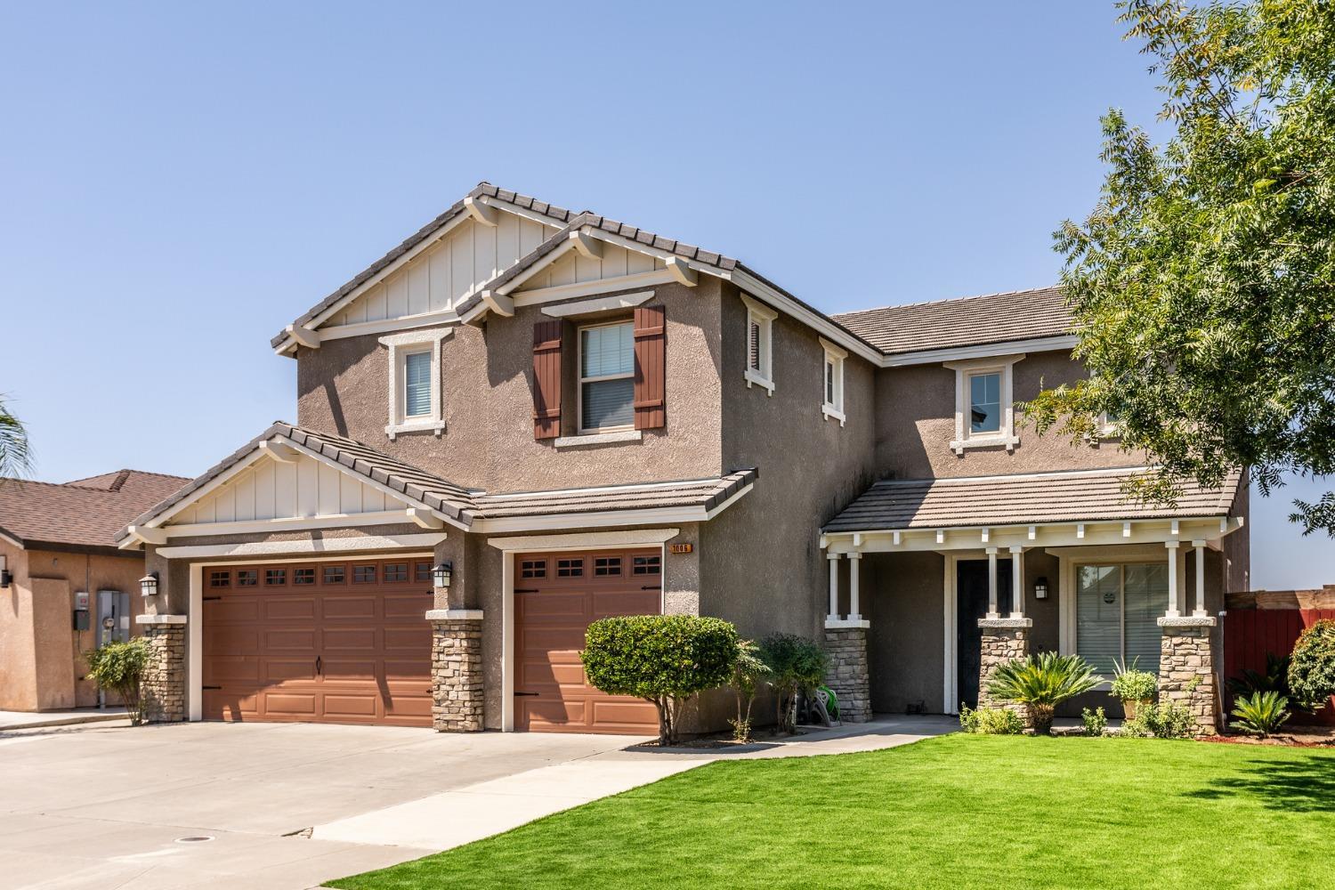 a front view of a house with a yard and porch