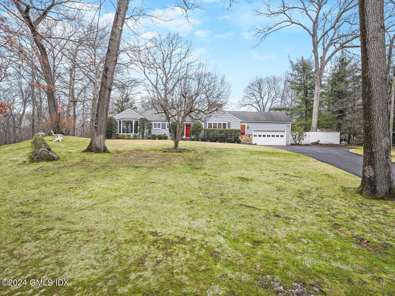 a view of a yard with a house and large trees