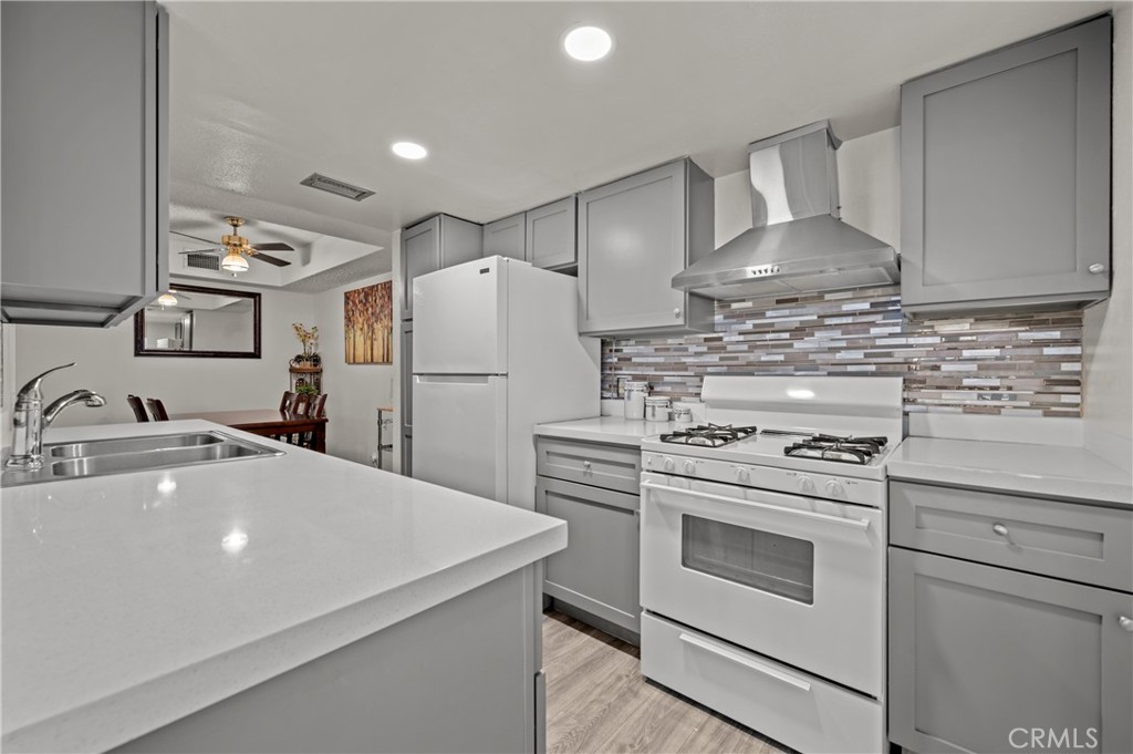 a kitchen with refrigerator a stove and a sink