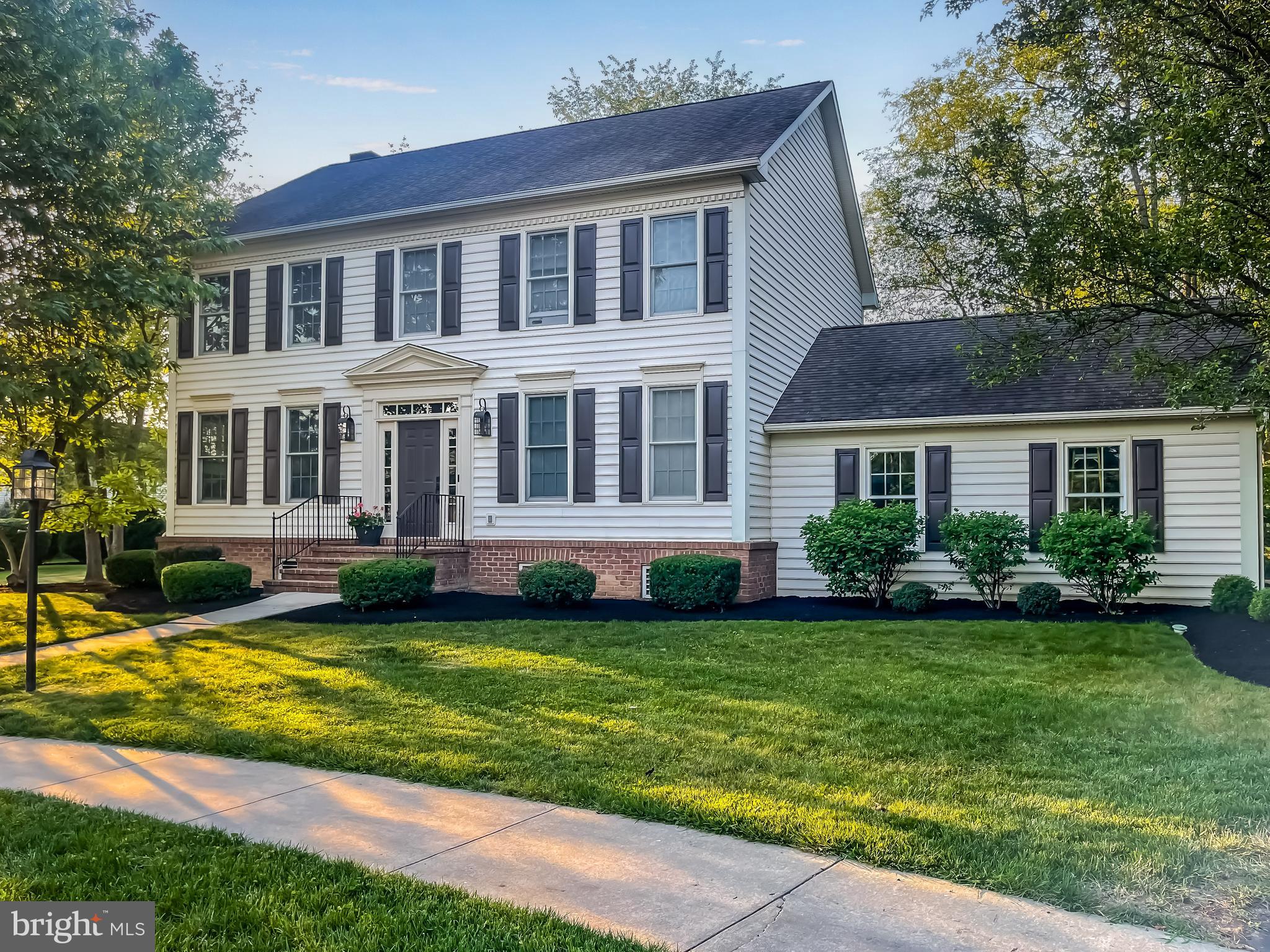 a view of a house with a yard deck and a small yard