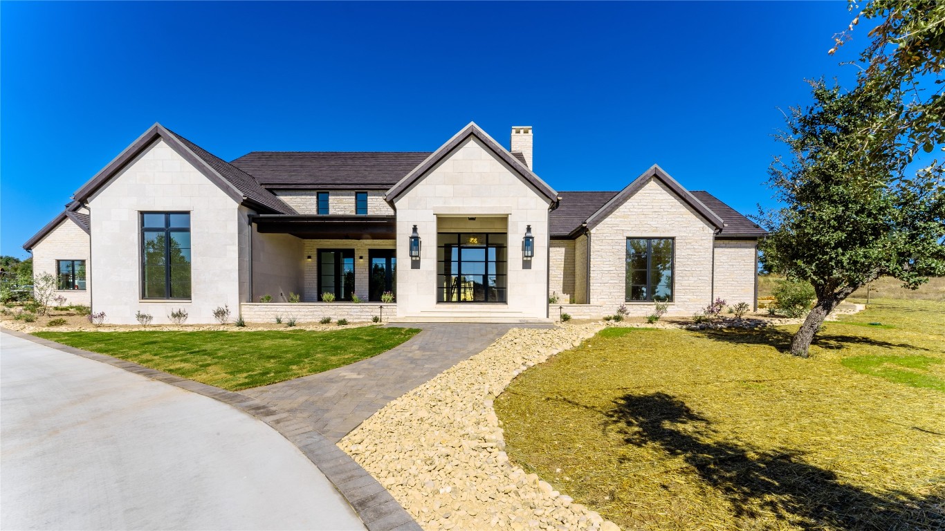 a view of a house with swimming pool and a yard