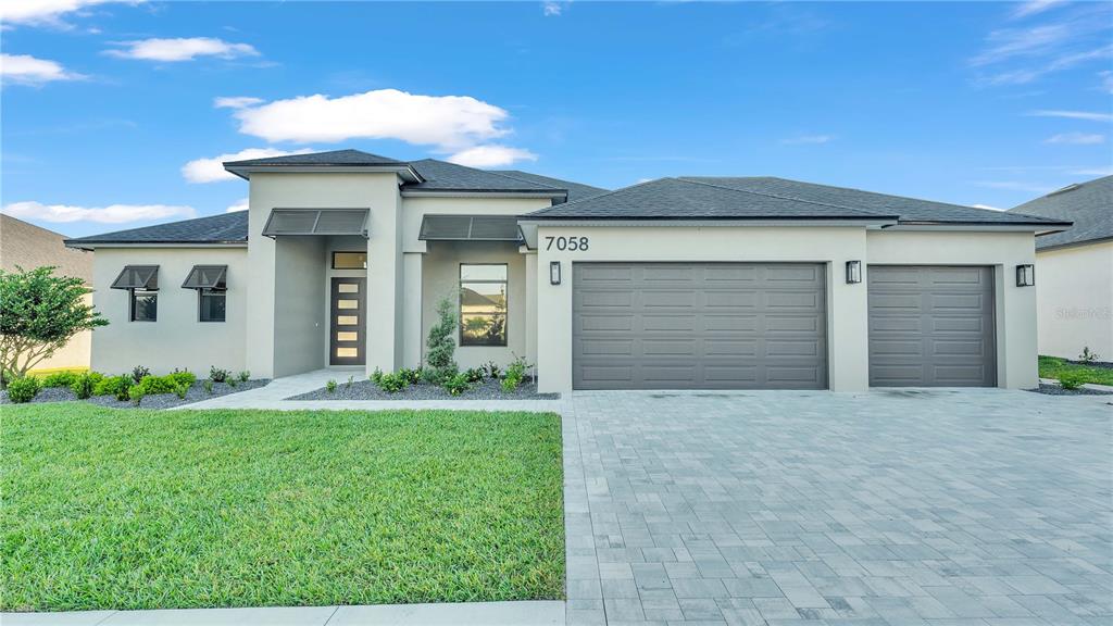 a front view of a house with a yard and garage