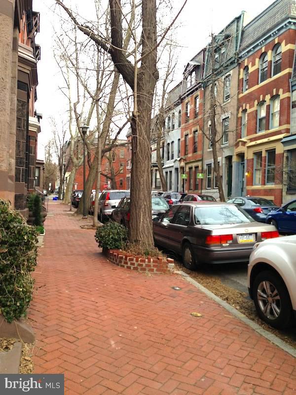 a view of street with parked cars