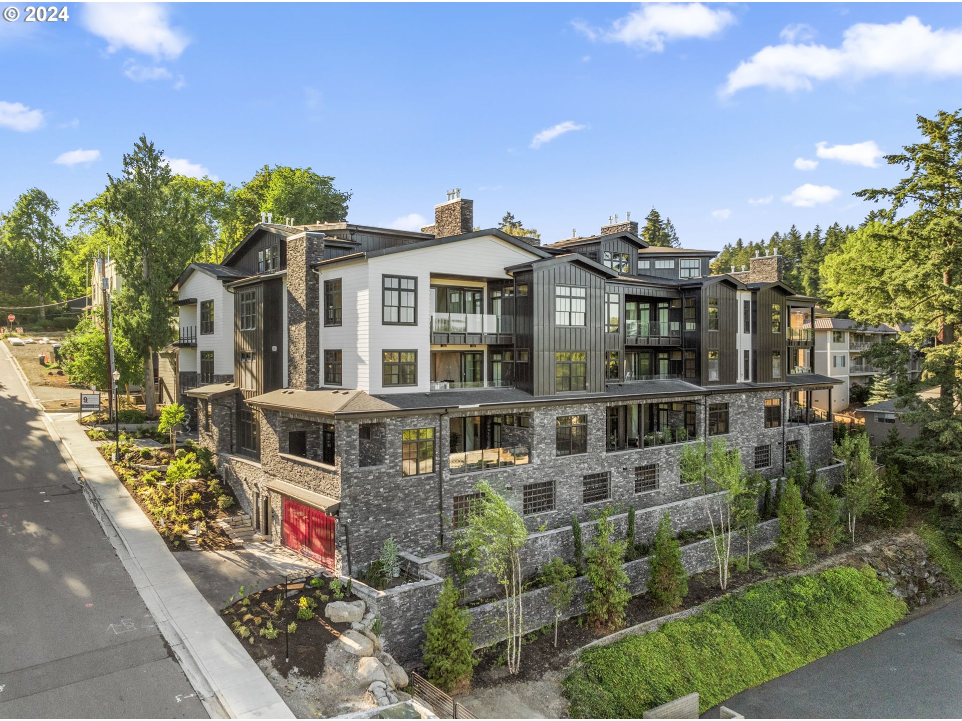 a front view of a multi story residential apartment building with a yard