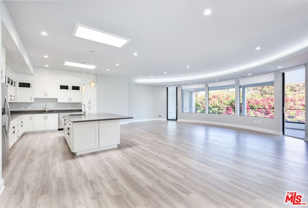 a view of kitchen with stove and wooden floor