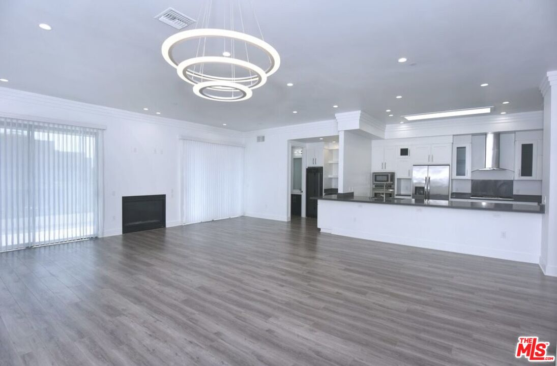 a view of kitchen and refrigerator