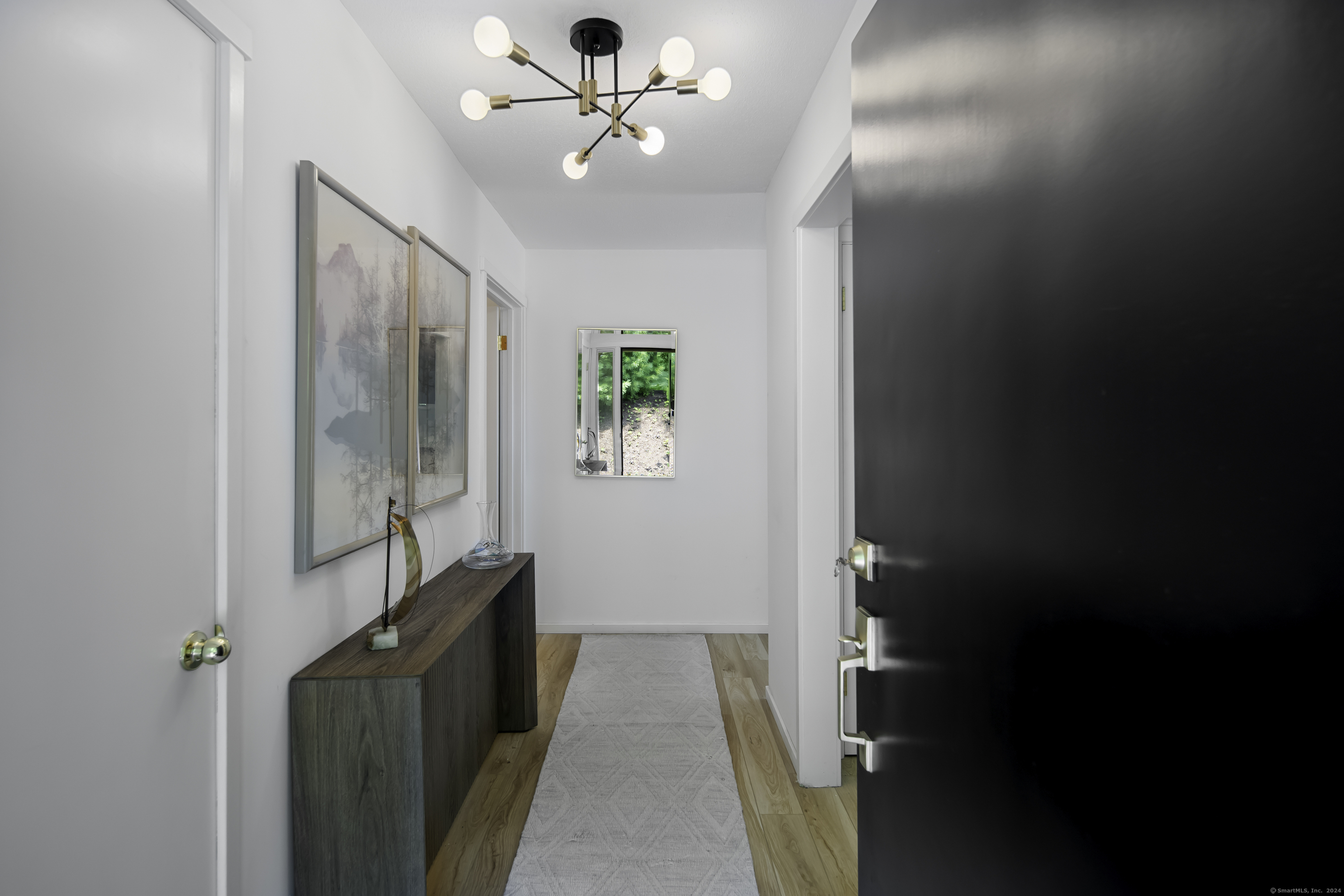 a view of a hallway with a chandelier