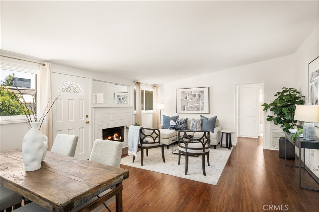 a living room with furniture fireplace and wooden floor