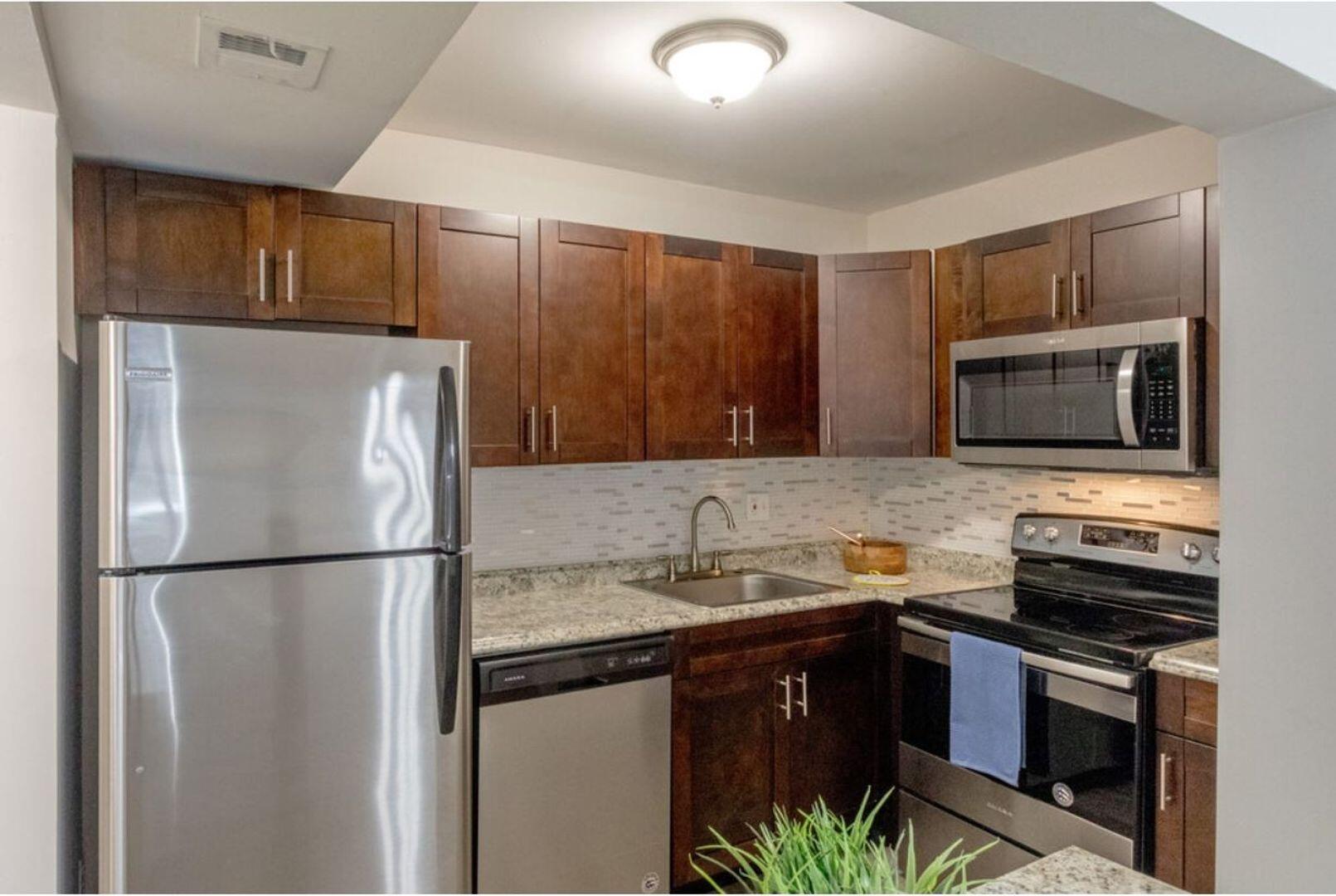 a kitchen with a refrigerator and a sink