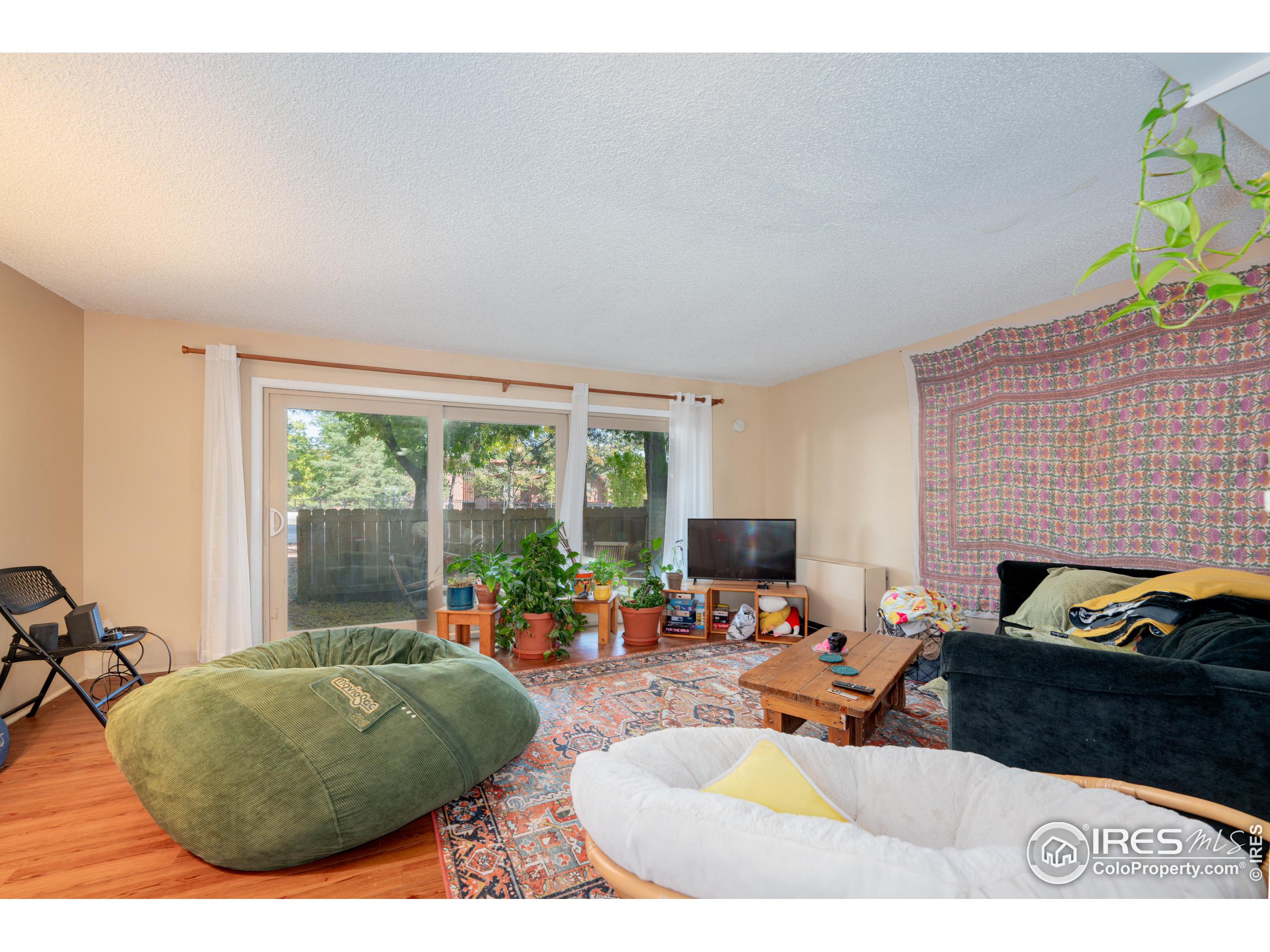 a living room with furniture and a floor to ceiling window