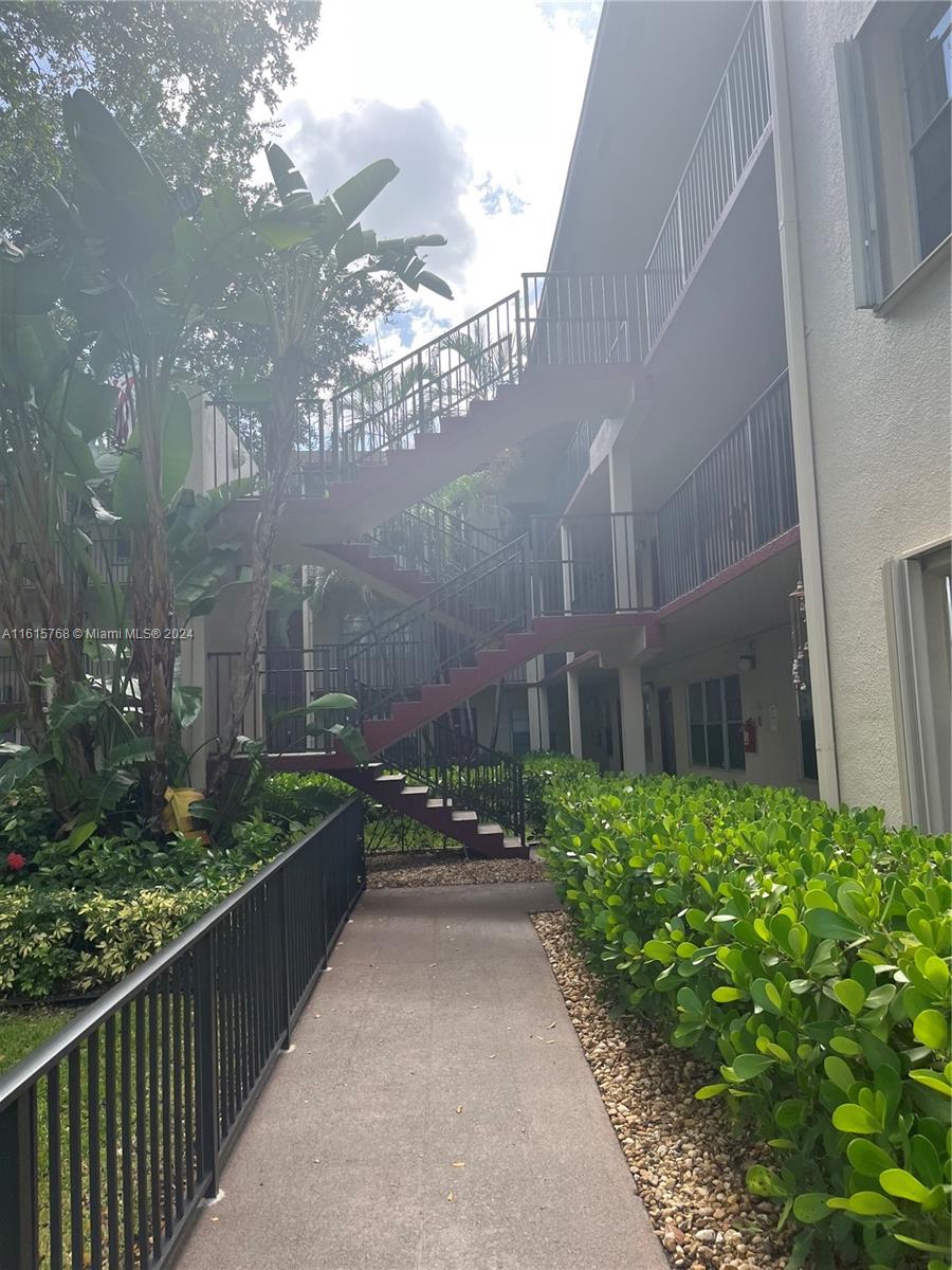 a view of a pathway both side of house