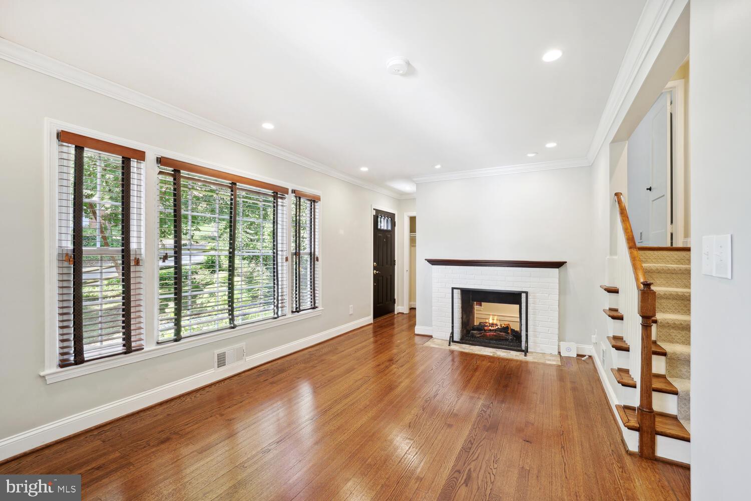 a view of an empty room with a fireplace and a window