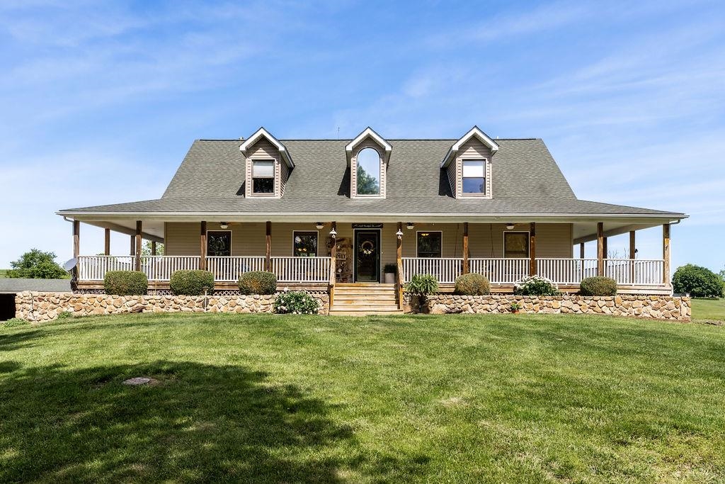 a front view of a house with a garden and patio