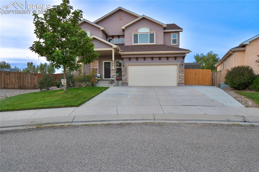 View of front of home featuring a front yard and a garage