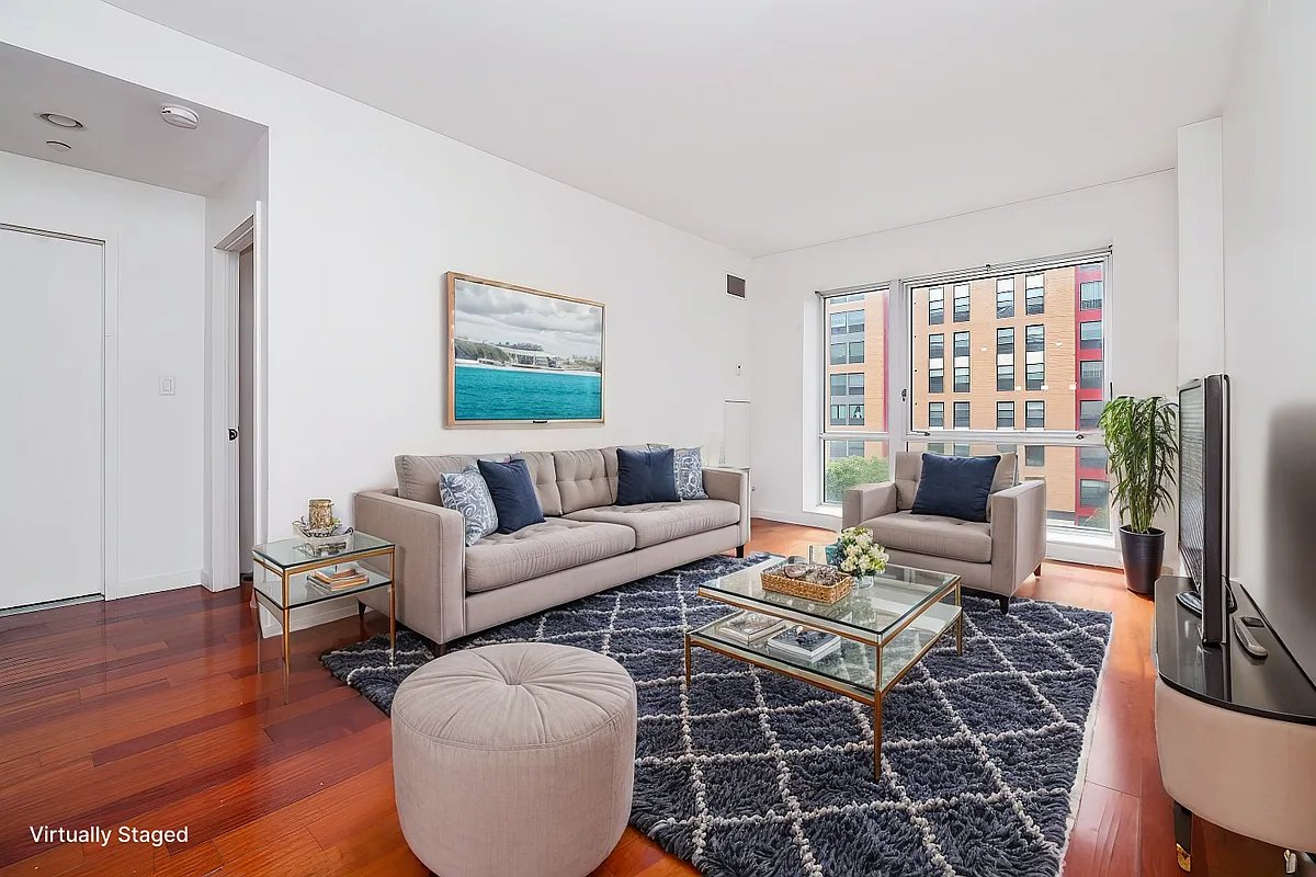 a living room with furniture a rug and a flat screen tv