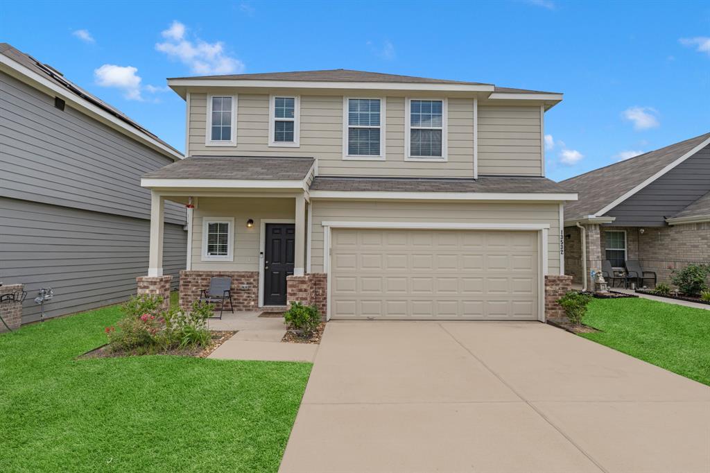 a front view of house with yard and green space