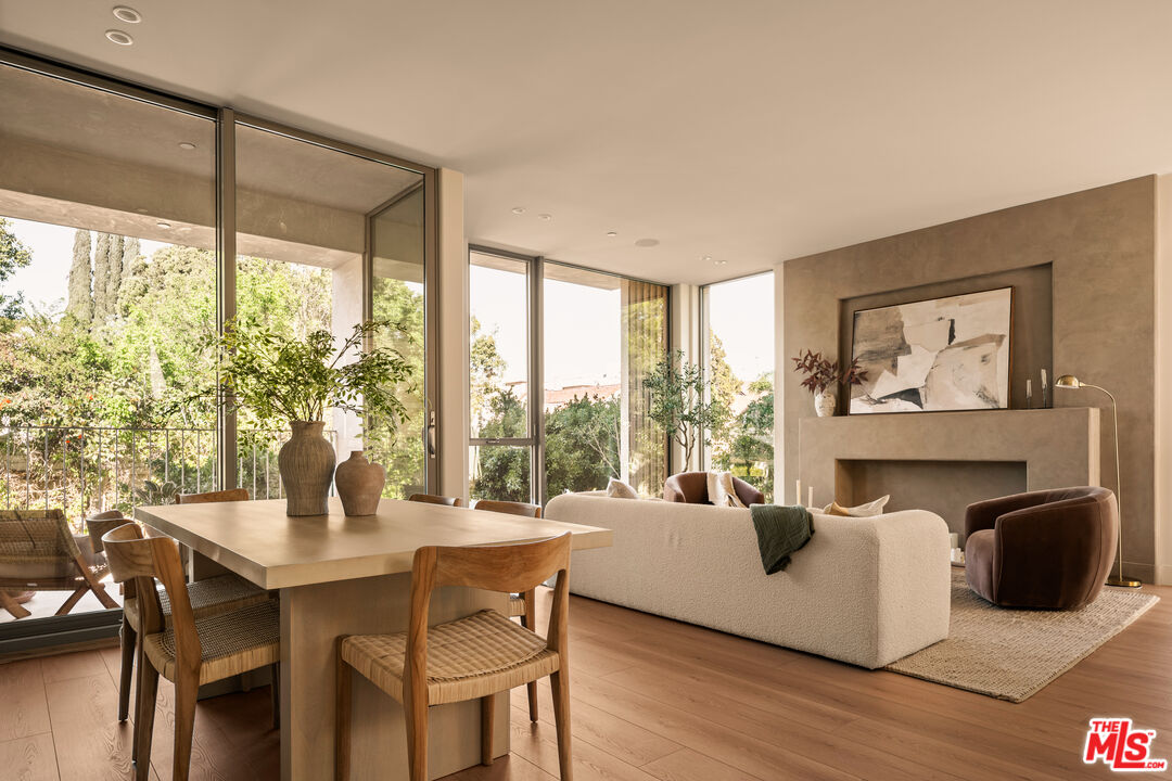 a living room with fireplace furniture and a large window