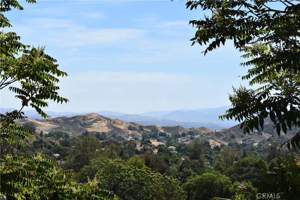 an aerial view of mountain with trees around