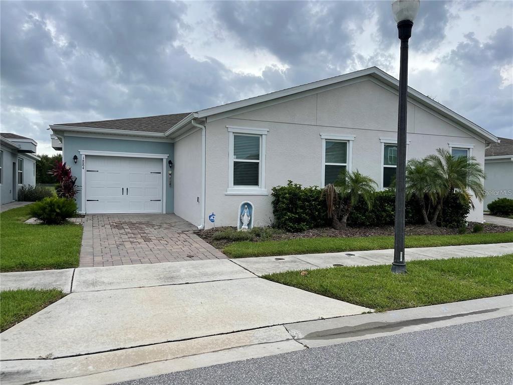 a front view of house with yard and green space