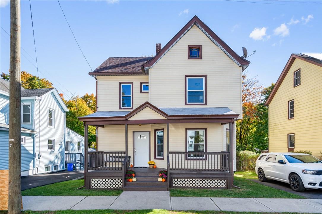 View of front of house featuring covered porch and off-street parking