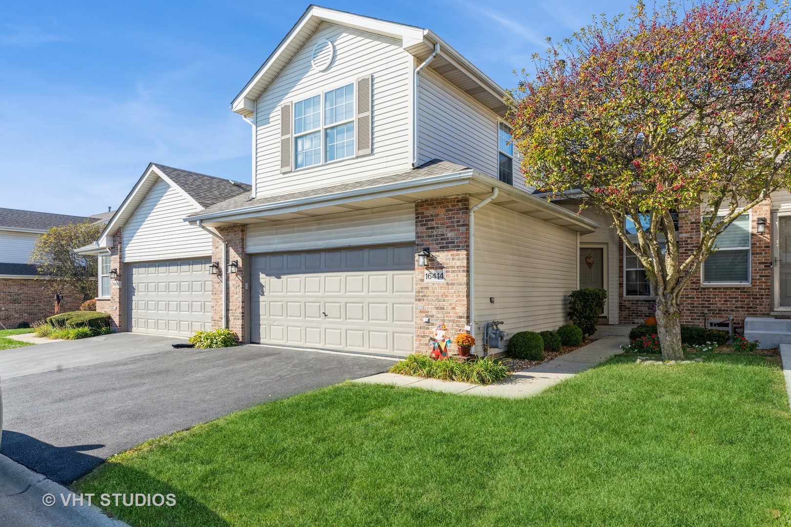 a front view of a house with a yard and garage