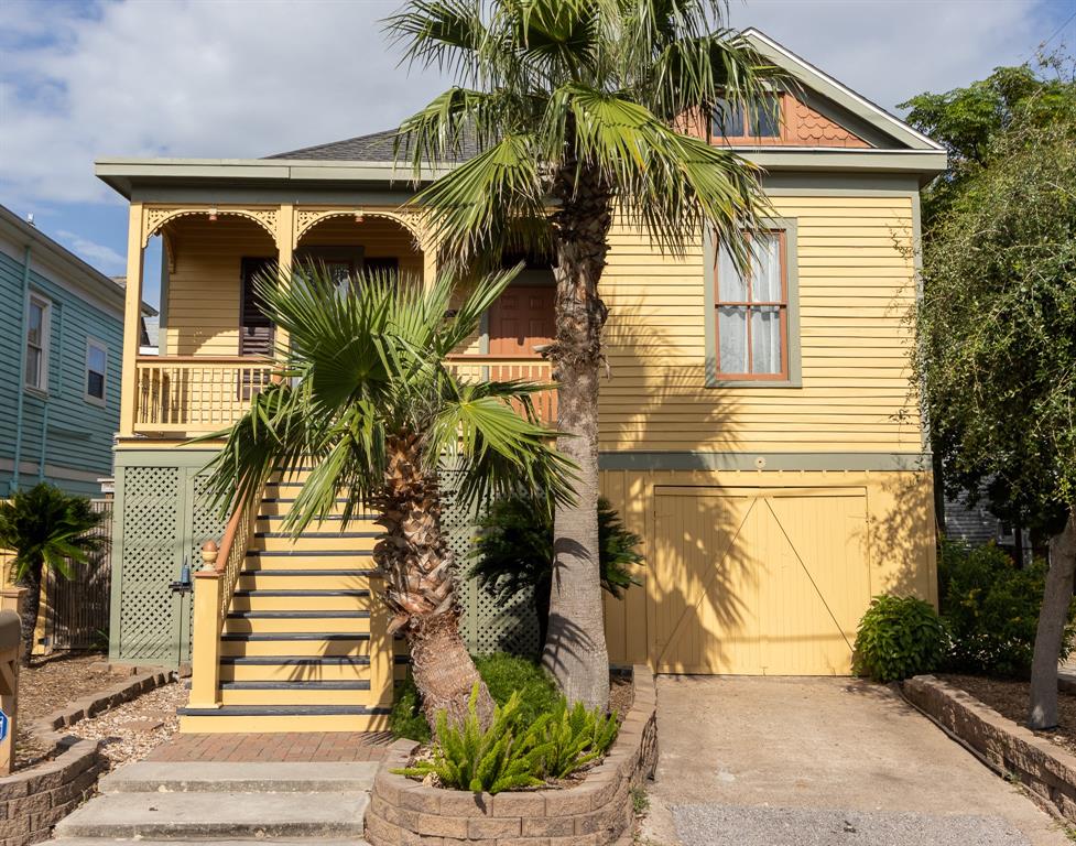 a view of a house with a palm tree