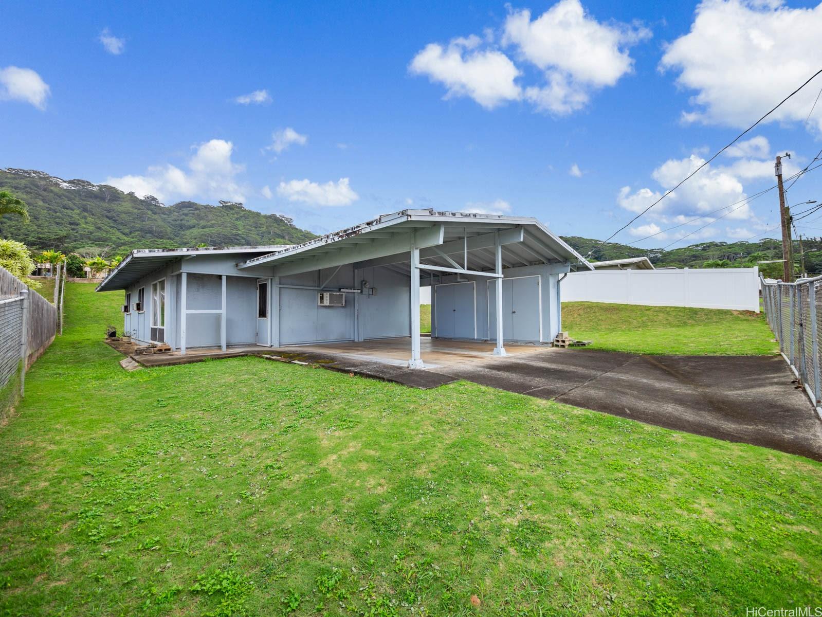 a view of a house with a backyard