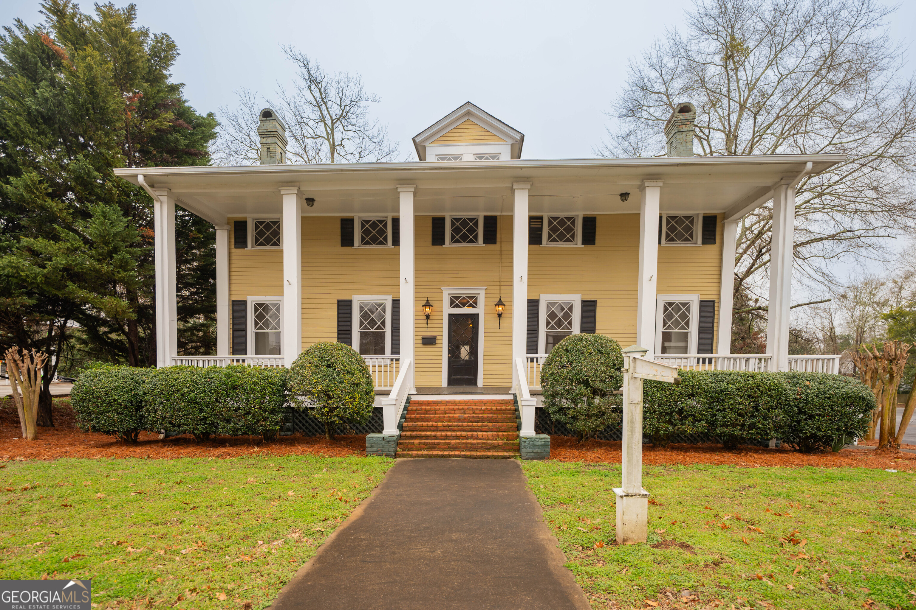 a front view of a house with garden