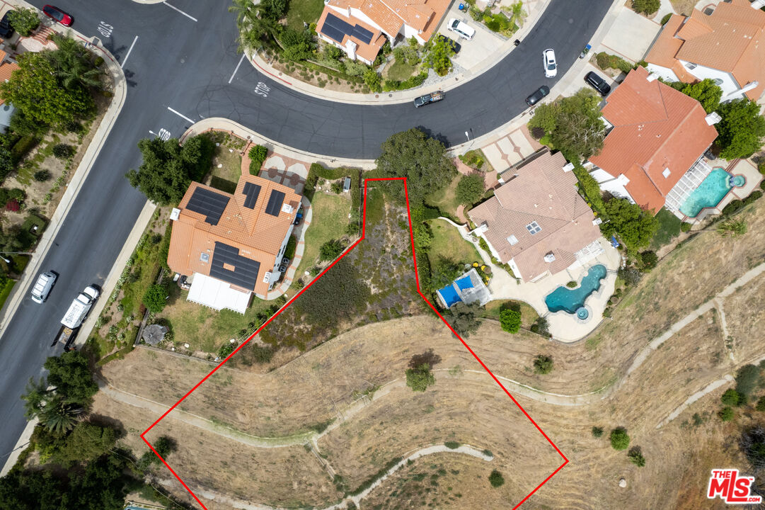 an aerial view of a house with a swimming pool