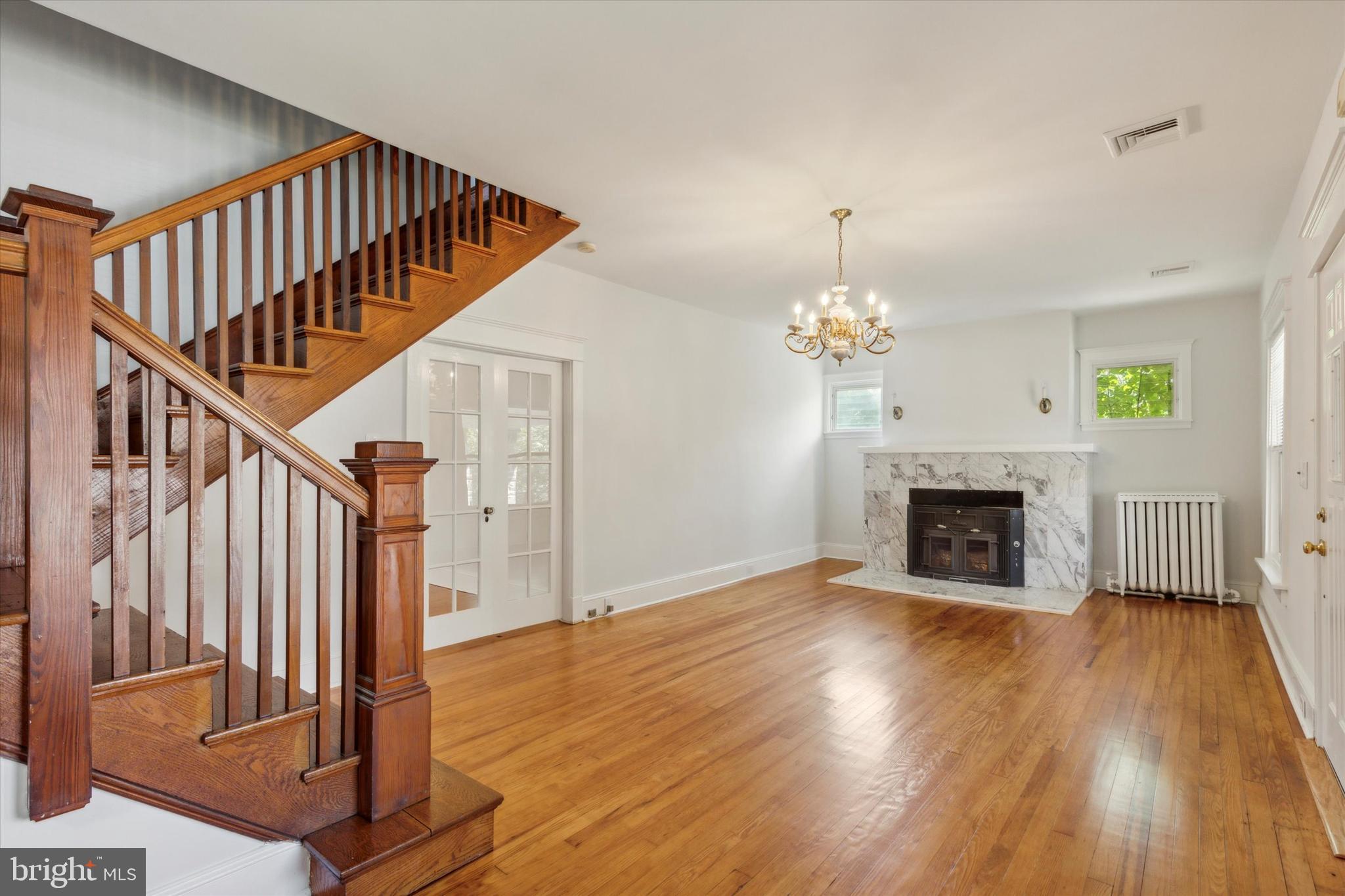 a view of a livingroom with wooden floor and staircase