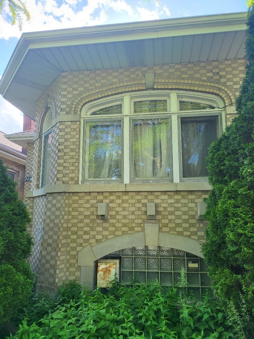 a view of a brick house with a window