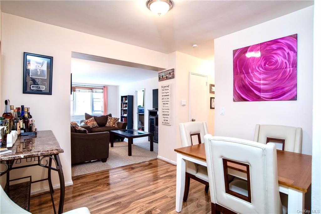 a living room with furniture a dining table and wooden floor