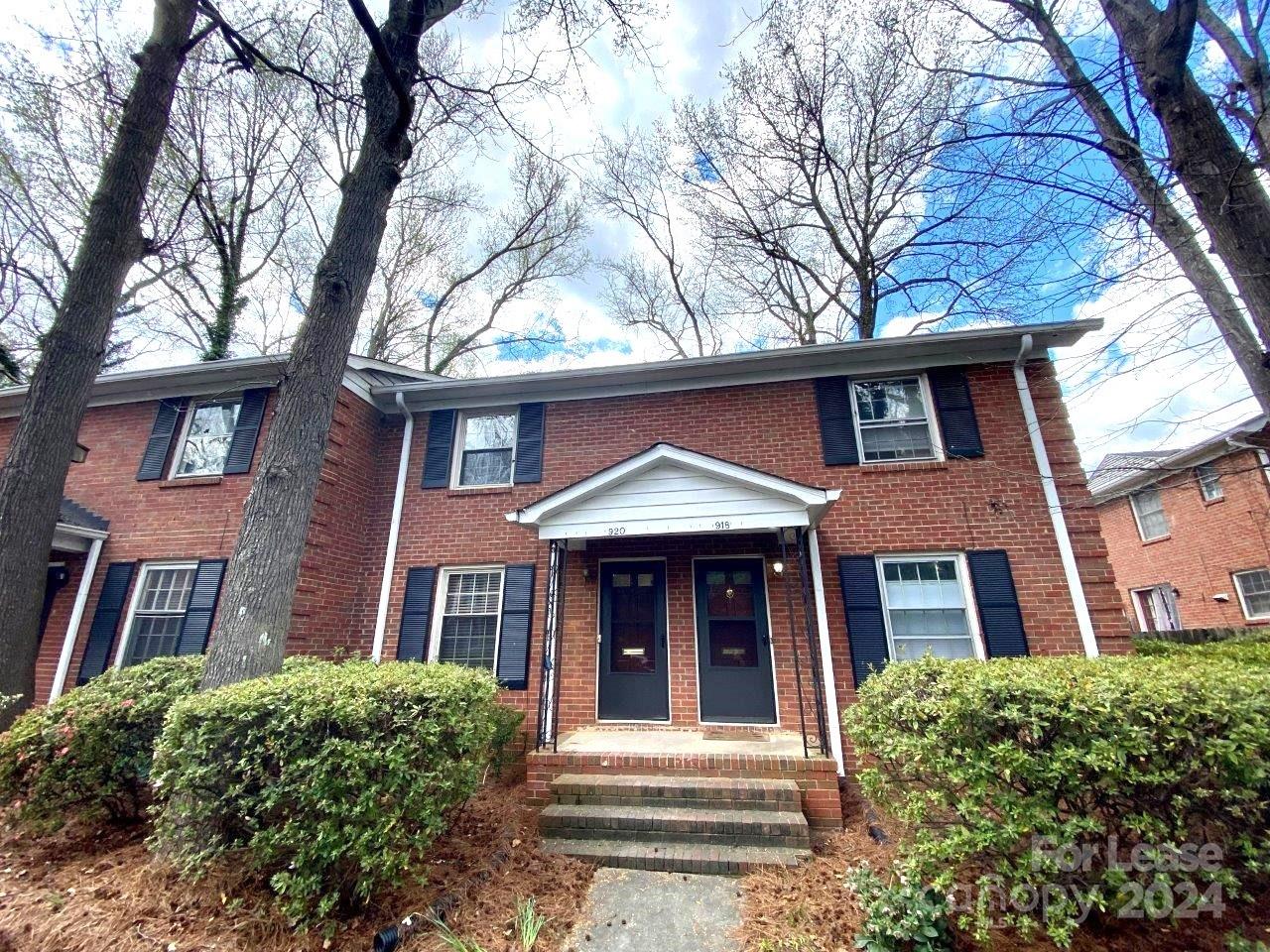 front view of a brick house with a large windows