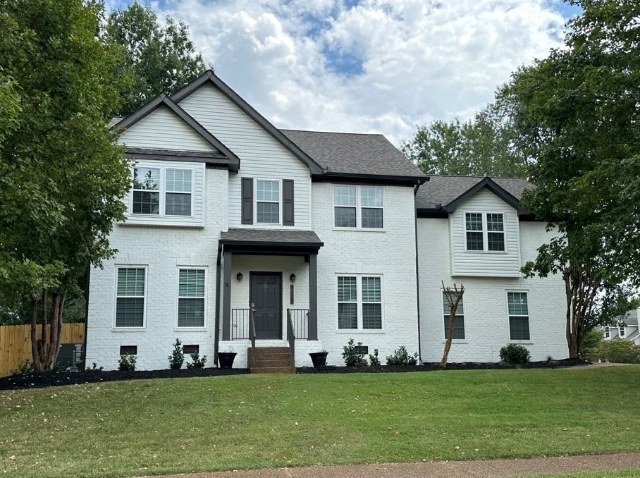 a front view of a house with a yard