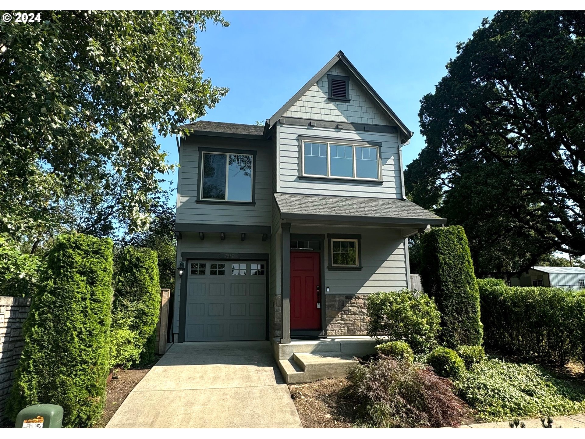 a front view of a house with a garden