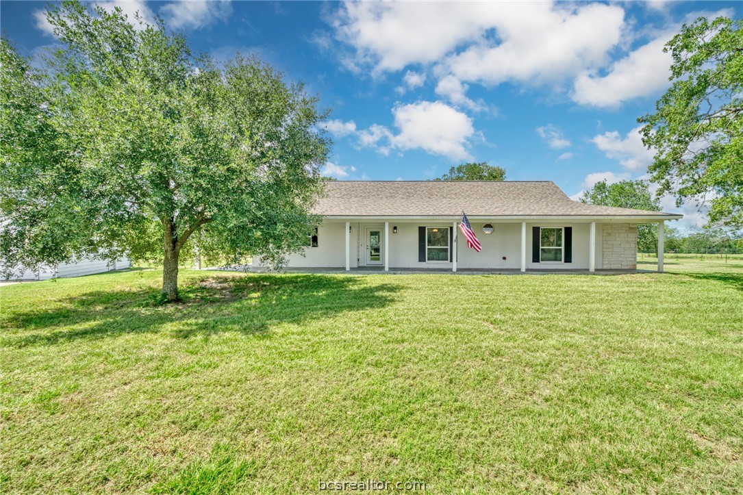 a front view of house with yard and green space