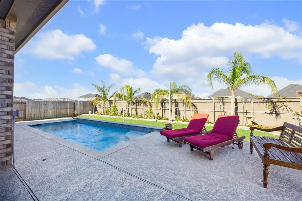 a view of swimming pool with sitting area