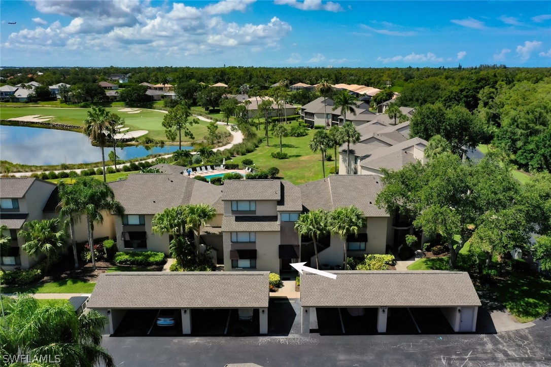 an aerial view of a house with swimming pool and outdoor seating