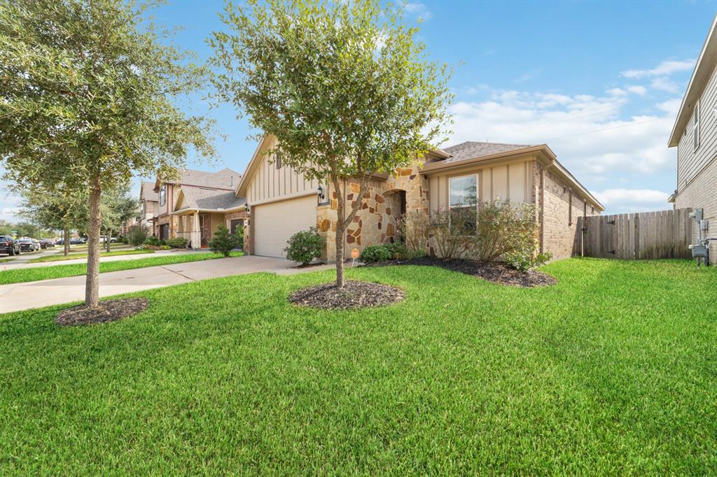 a front view of a house with a yard and trees