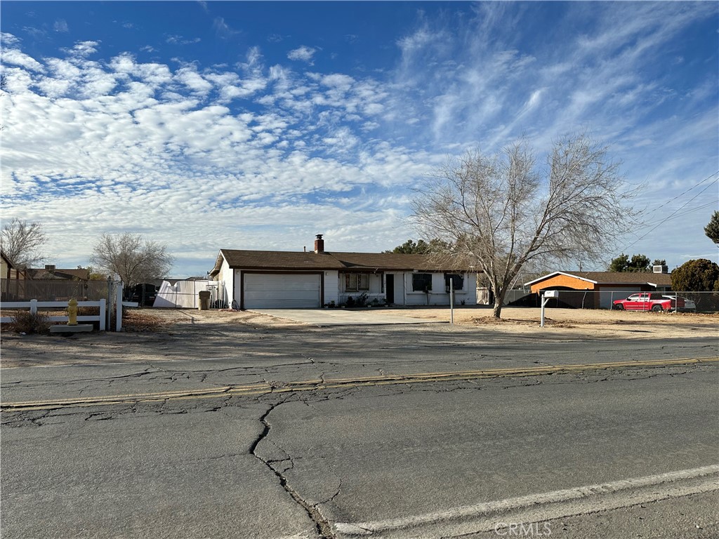 a view of a car parked on the side of the road with large building