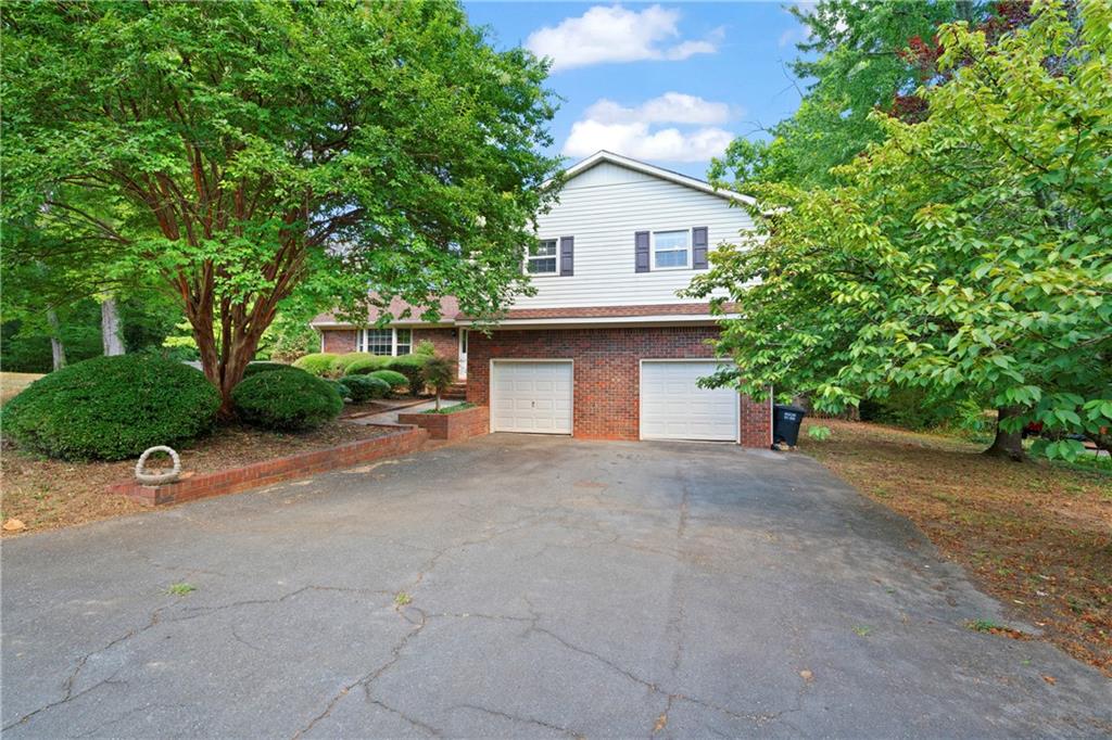 a view of a house with a yard and garage