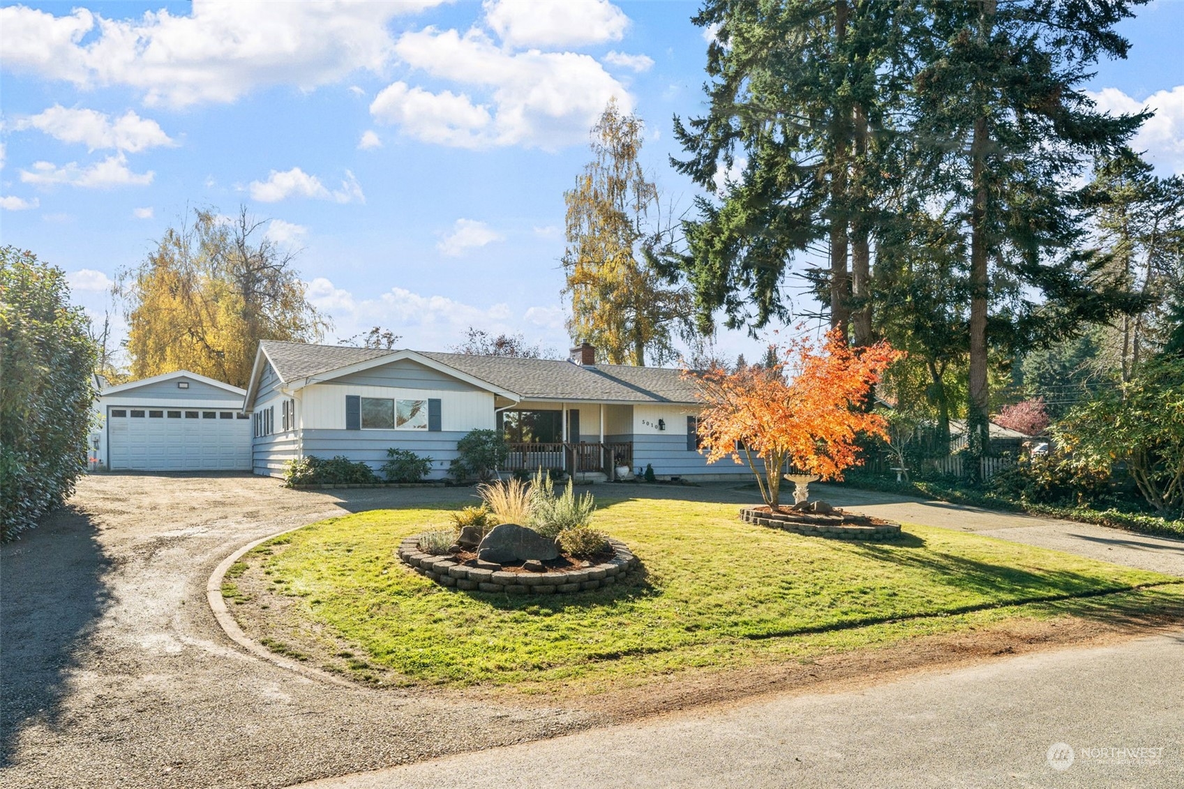 a front view of a house with a yard fountain and garage