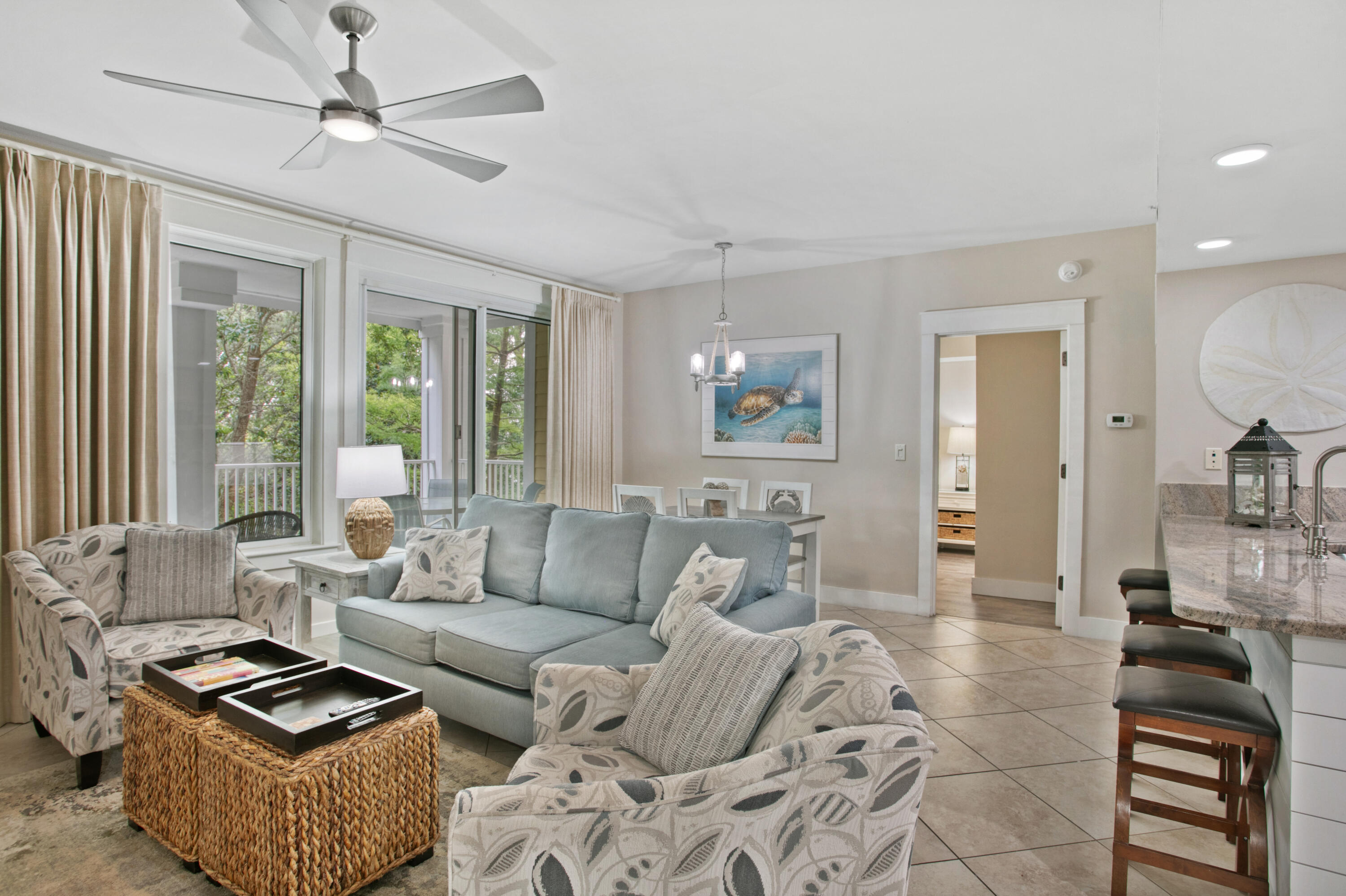 a living room with furniture a large window and a rug