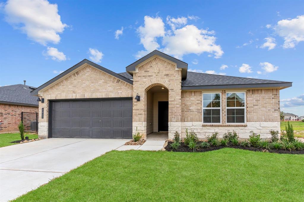 a front view of a house with a yard and garage