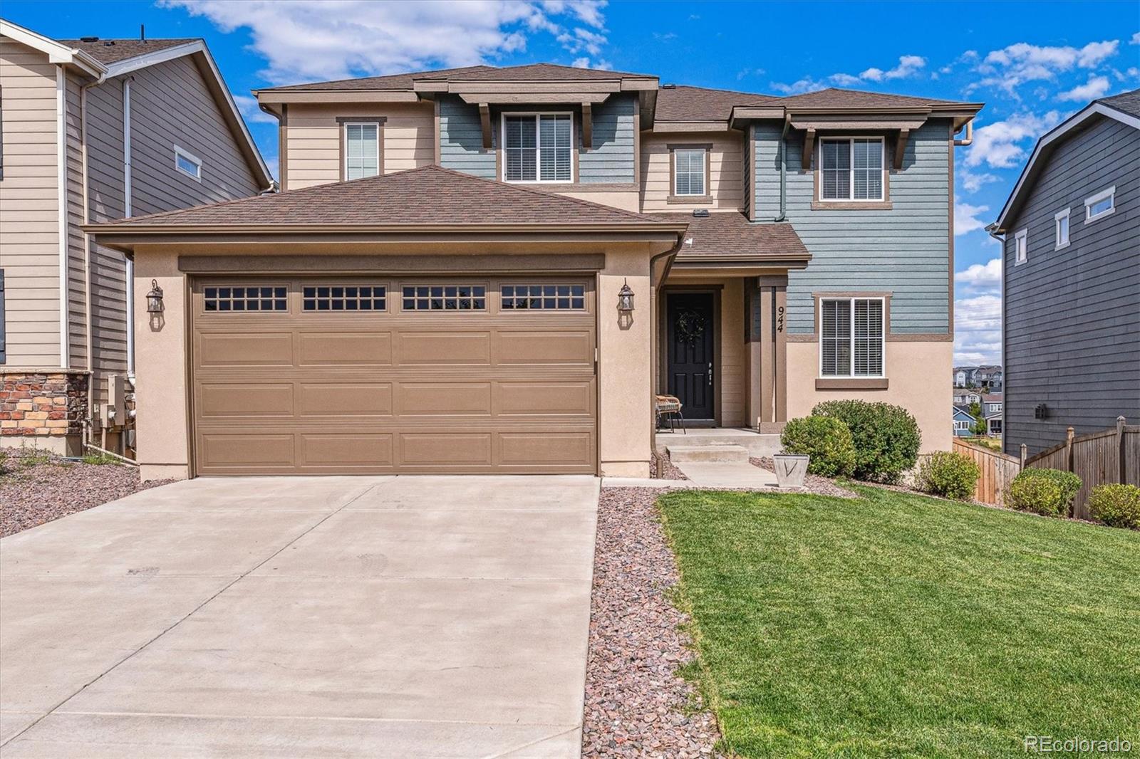 a front view of a house with a yard and garage