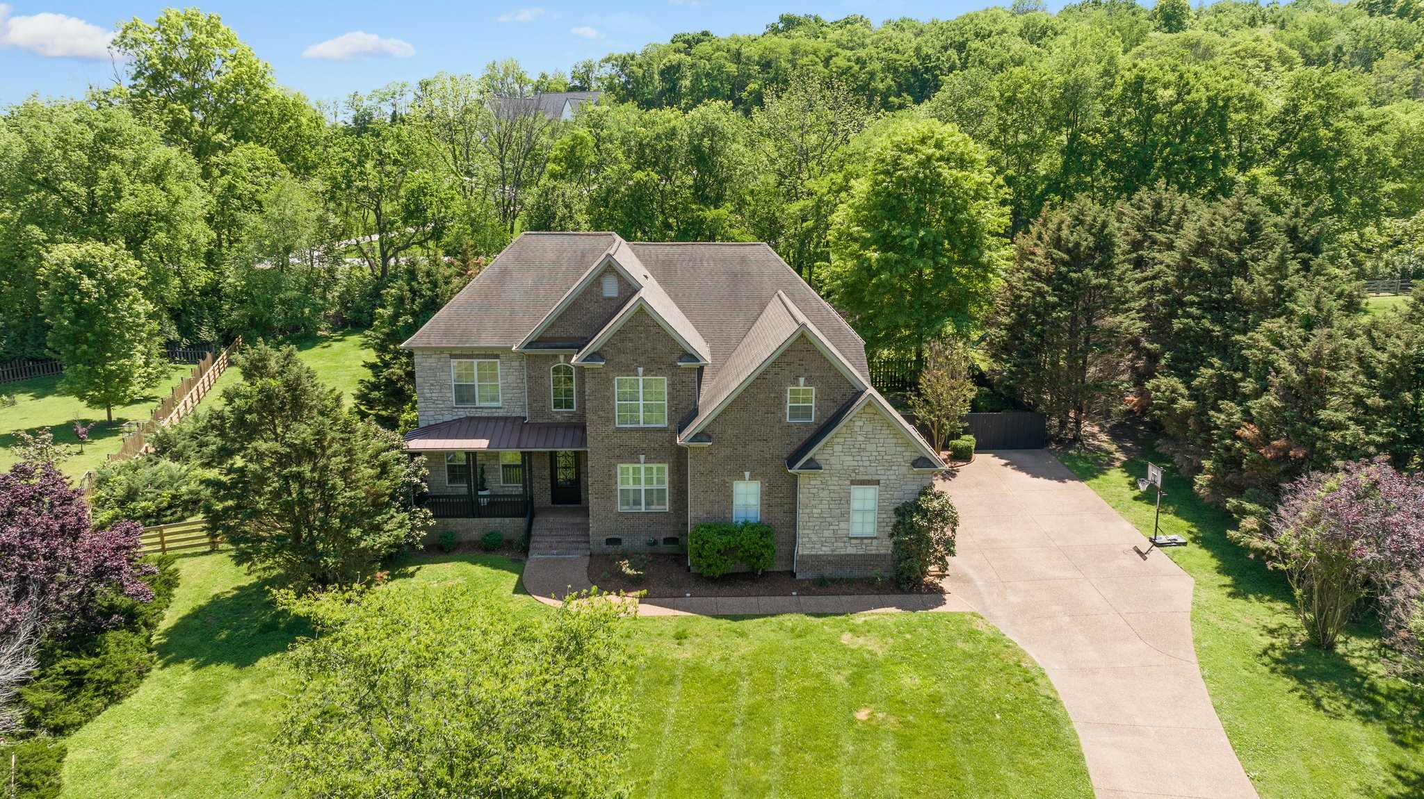 a view of house with yard and green space