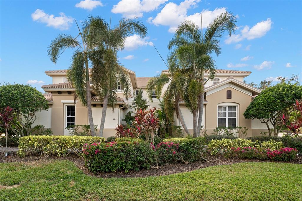 a front view of a house with a garden