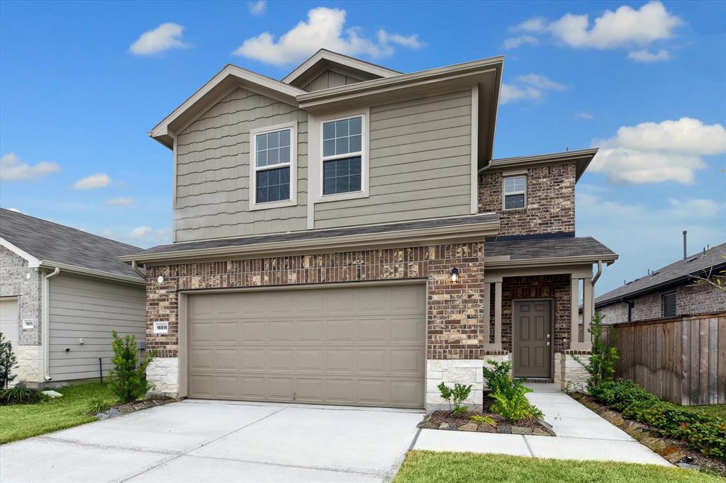 a front view of a house with a yard and garage