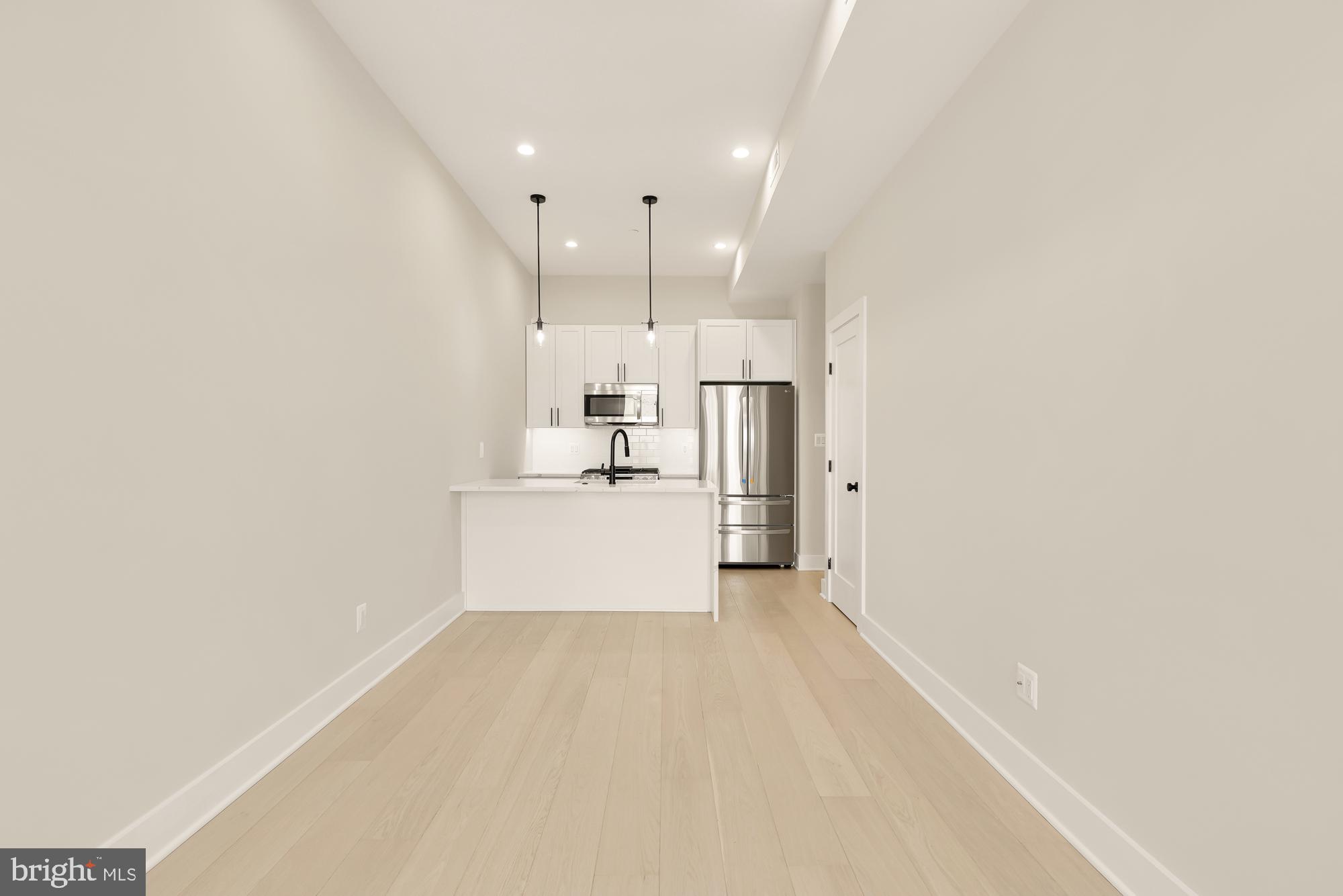 a view of kitchen with wooden floor