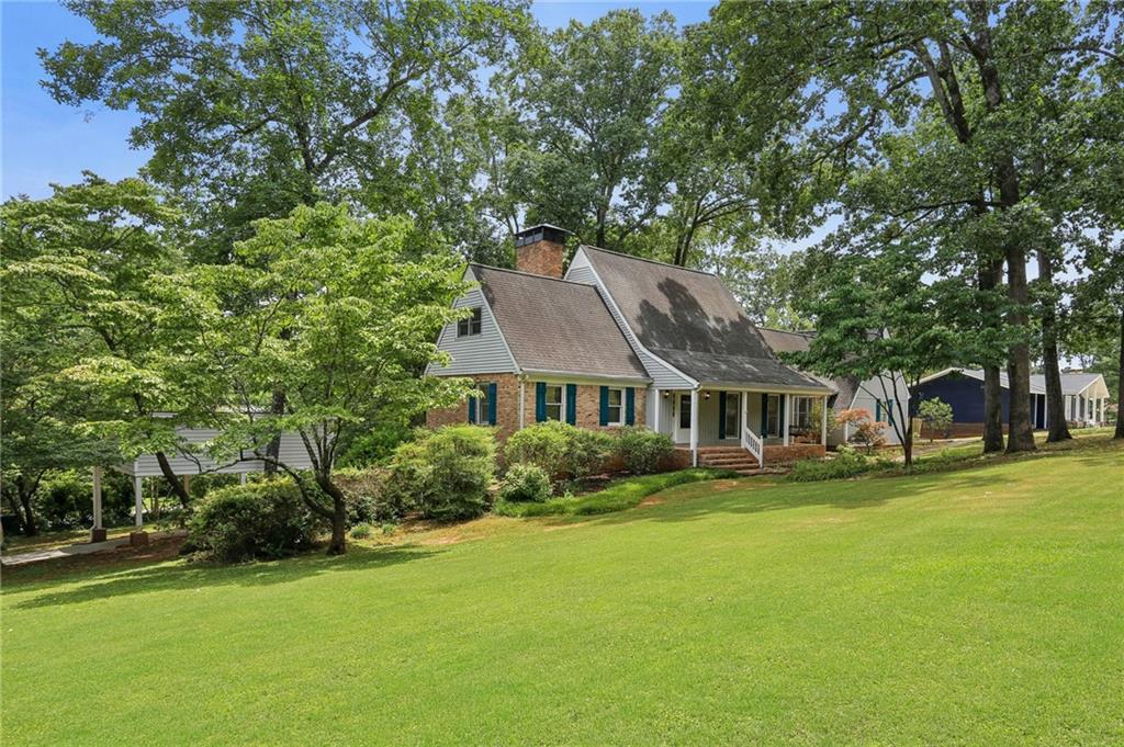 a front view of a house with a garden